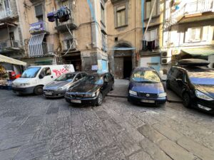 Co zobaczyć w Neapolu? Samochody na polskich numerach rejestracyjnych zaparkowane na osiedlu.